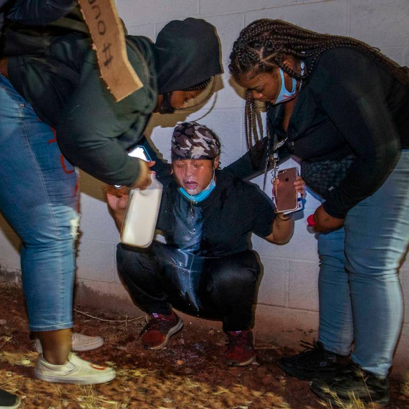 Protesters come to the aid of another who was tear gassed by Las Vegas police during a Black Li ...
