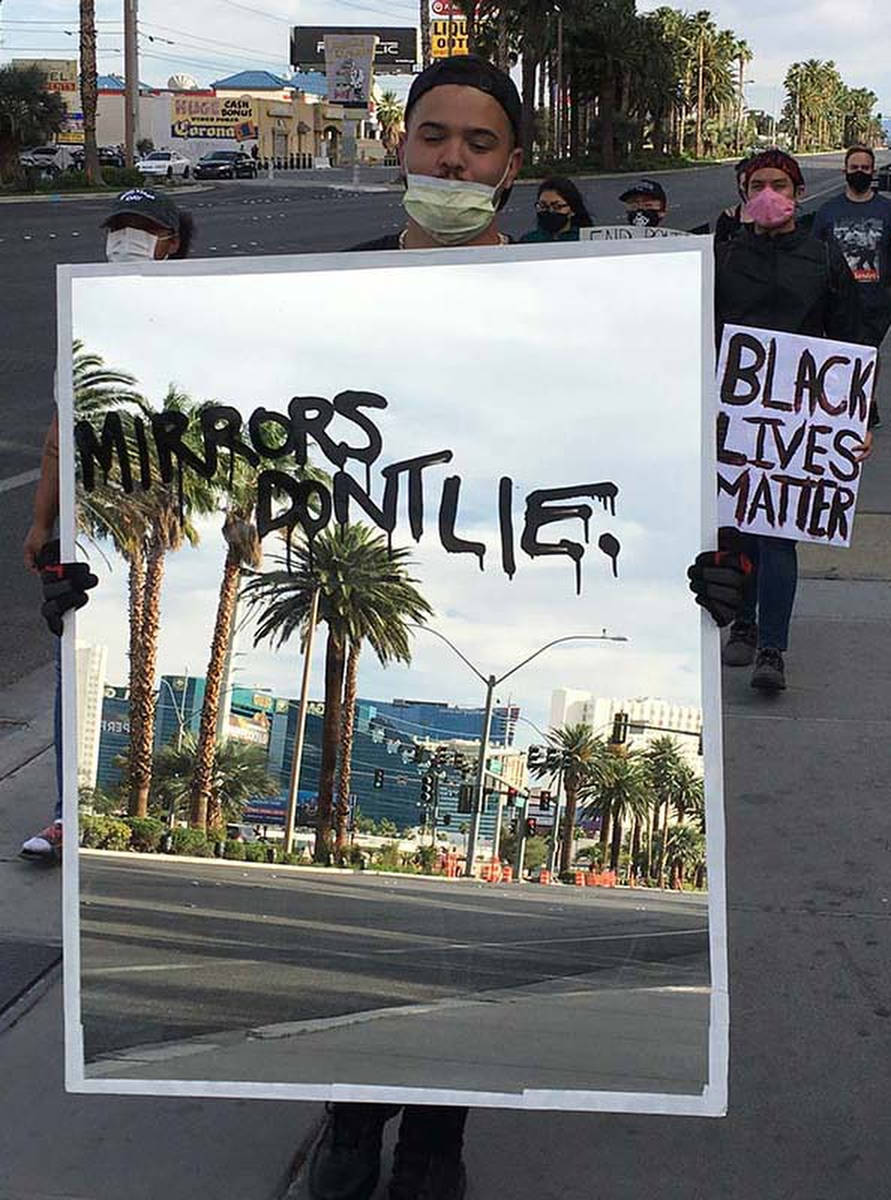 Audra Kelly, a 27-year-old Las Vegas artist, carries a 30-pound mirror at the Black Lives Matte ...