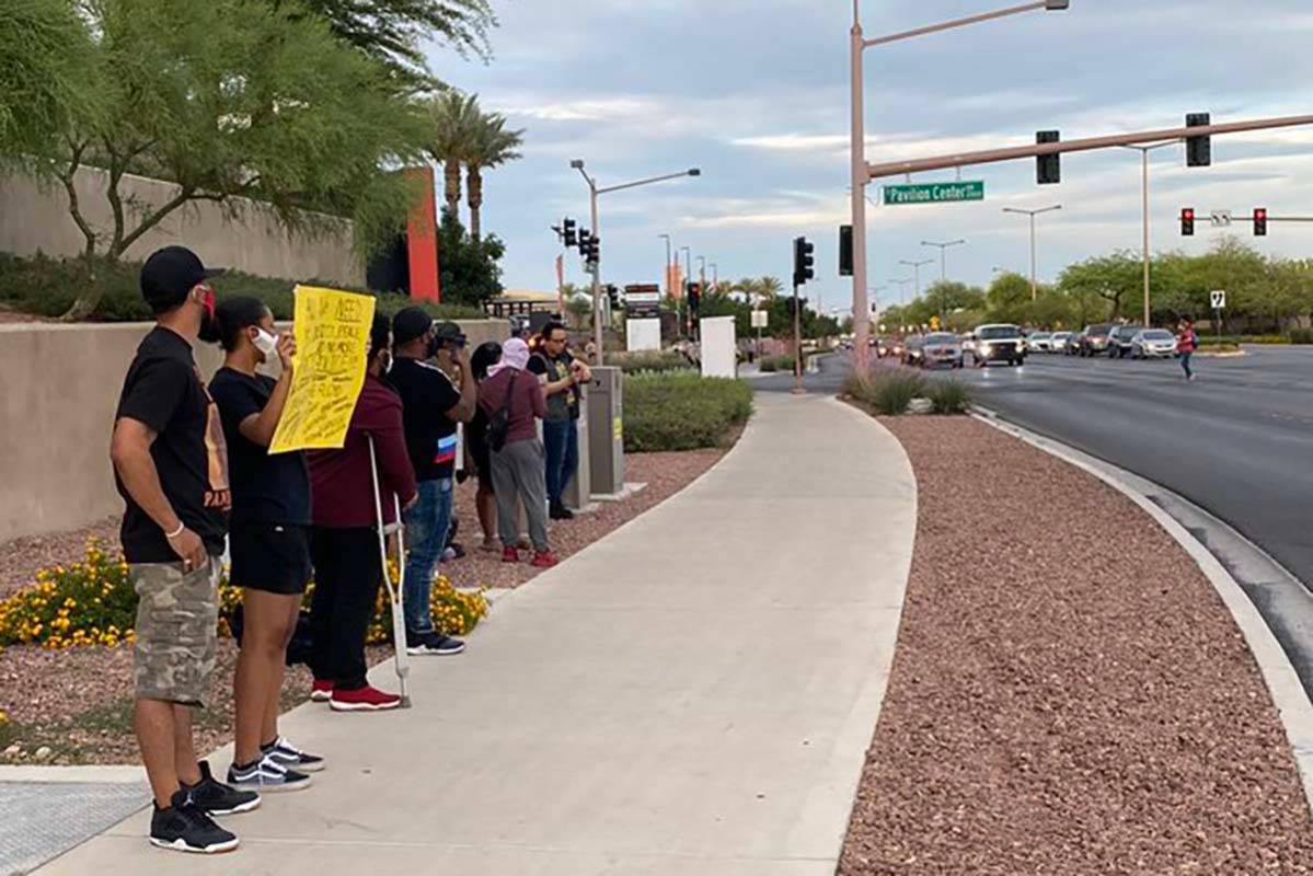 Black Lives Matter protesters stand outside Downtown Summerlin, Sunday, May 31, 2020. (Mick Ake ...