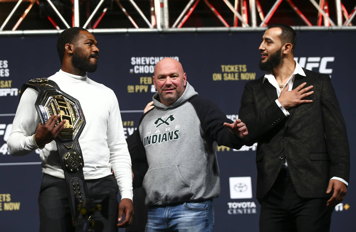 UFC President Dana White, center, looks on as Jon Jones, left, and Dominick Reyes face off duri ...