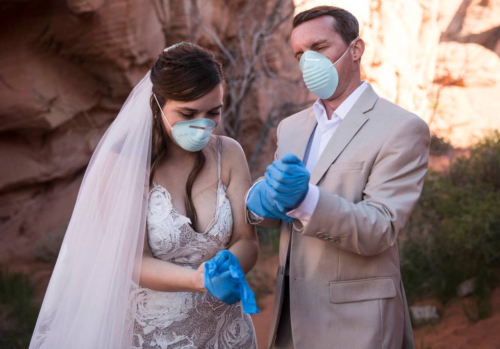 After the ceremony, Ashley and Will Hinder don protective gear for photos to commemorate the da ...