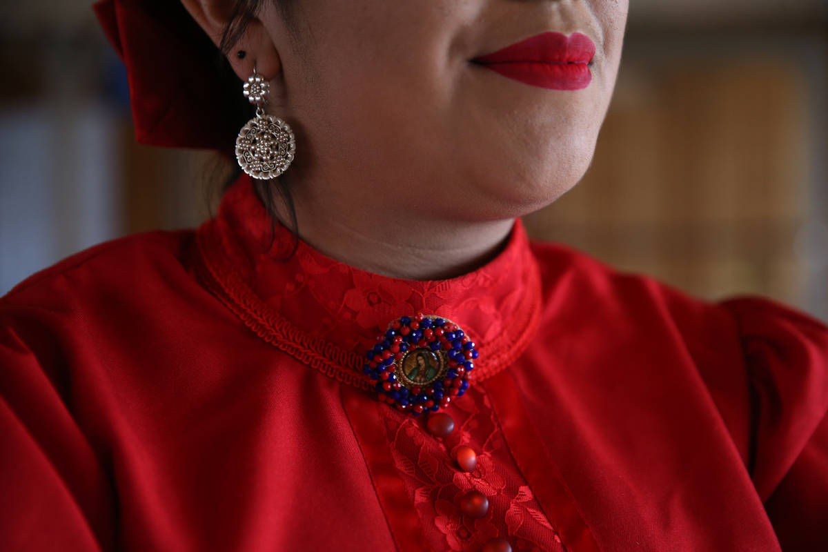 Denyse Cabrera, 18, is ready to perform after attending to final details of her apparel. (Erik ...