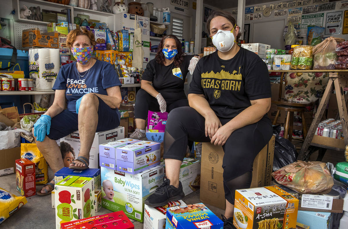 Donna West, from left, Jeana Blackman Taylor and Annette Magnus with donations in West's garage ...