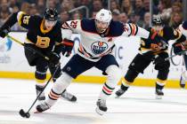 Edmonton Oilers' Leon Draisaitl (29) brings the puck up in front of Boston Bruins' Brandon Carl ...