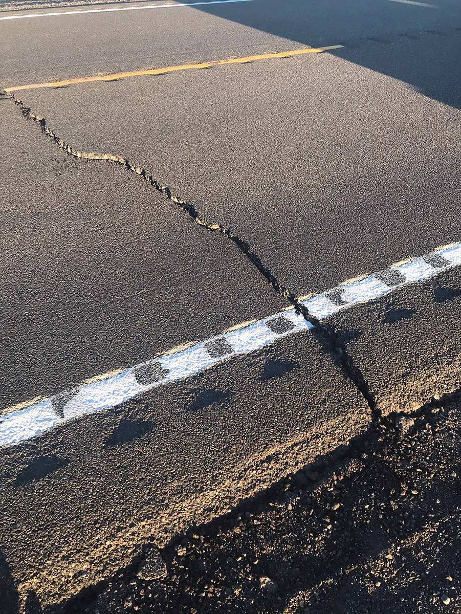 Cracks in the pavement show some of the damage caused to U.S. Route 95 by a May 15 earthquake c ...