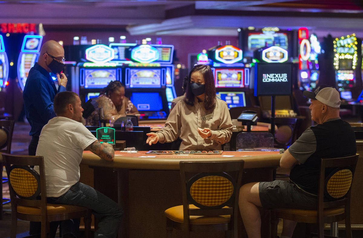 Gamblers play blackjack with empty seats on each side to maintain social distancing at TI on Th ...