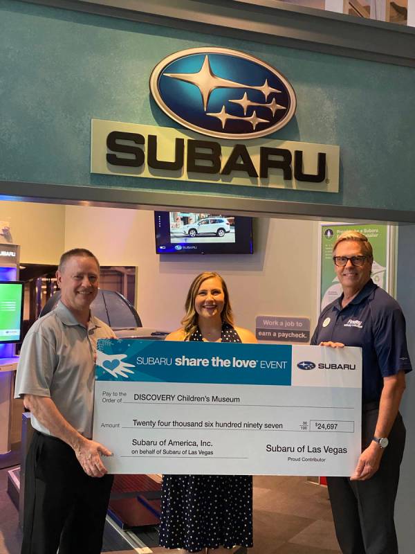 Caitlin Shea, director of development of the Discovery Children’s Museum, receives a check fo ...