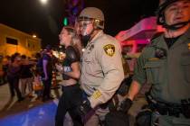 Las Vegas Police officers detain a protester from a Black Lives Matter march at Container Park ...