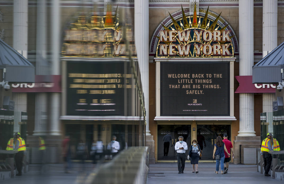 People walk across the pedestrian toward New York-New York on the Las Vegas Strip on Thursday, ...