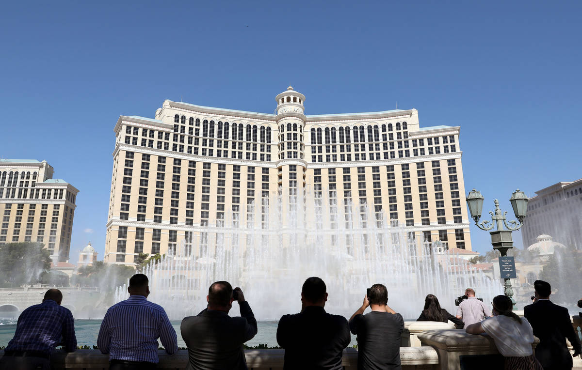 People watch the "Simple Gifts" Bellagio Fountains show as a tribute to frontline workers in La ...