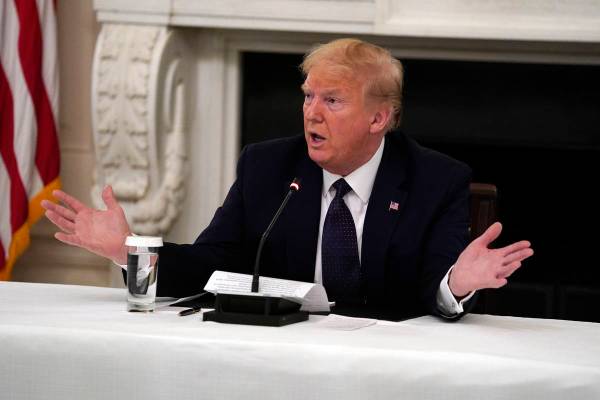 FILE - In this May 18, 2020 file photo, President Donald Trump tells reporters that he is takin ...