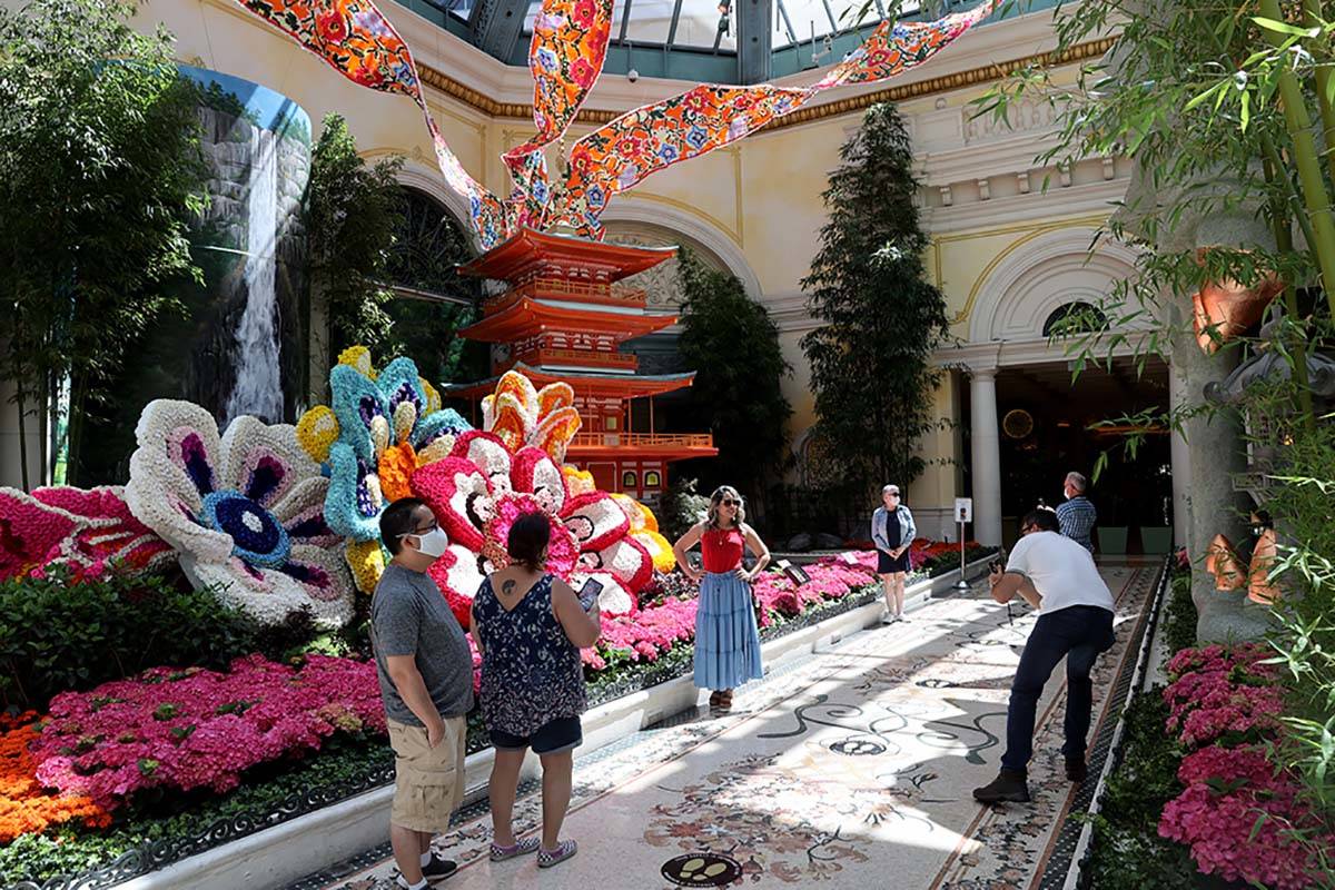 Guests maintain social distance inside the Conservatory at the Bellagio on the Las Vegas Strip, ...