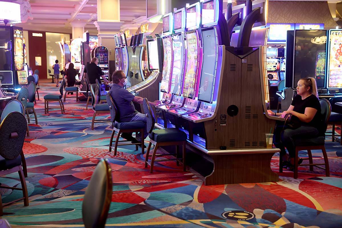 Guests play slots at the Bellagio on the Las Vegas Strip as the resort reopens after 78 days sh ...