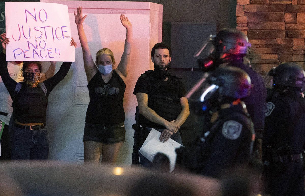 Jorge Gomez, 25, participates in a protest for George Floyd, a black man who was killed by Minn ...