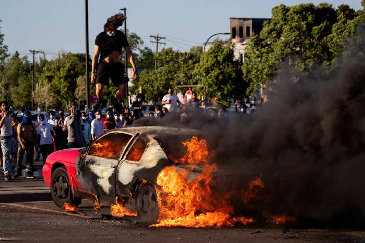 A car burns in a Target parking lot Thursday, May 28, 2020, in Minneapolis. Minnesota Gov. Tim ...