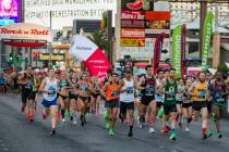 Elite runners leave the starting line during the Las Vegas Rock 'n' Roll Marathon along the Str ...
