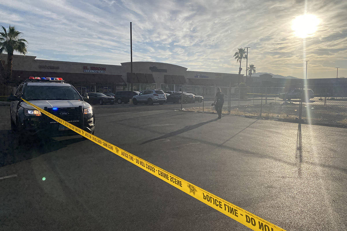 Crime scene tape stretches across a parking lot at Pecos-McLeod Plaza, 3050 E. Desert Inn Road, ...