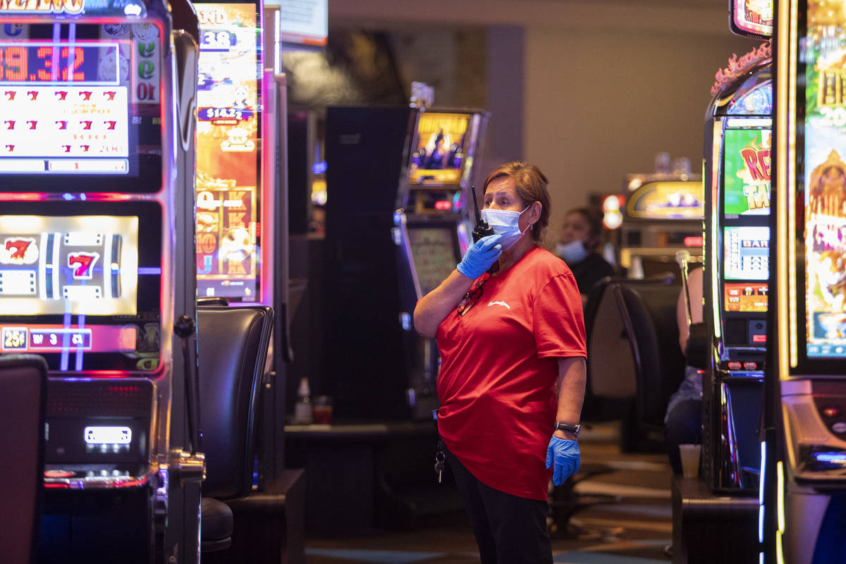 Employees wore masks and gloves while cleaning the casino floor at Palace Station on Sunday, Ju ...