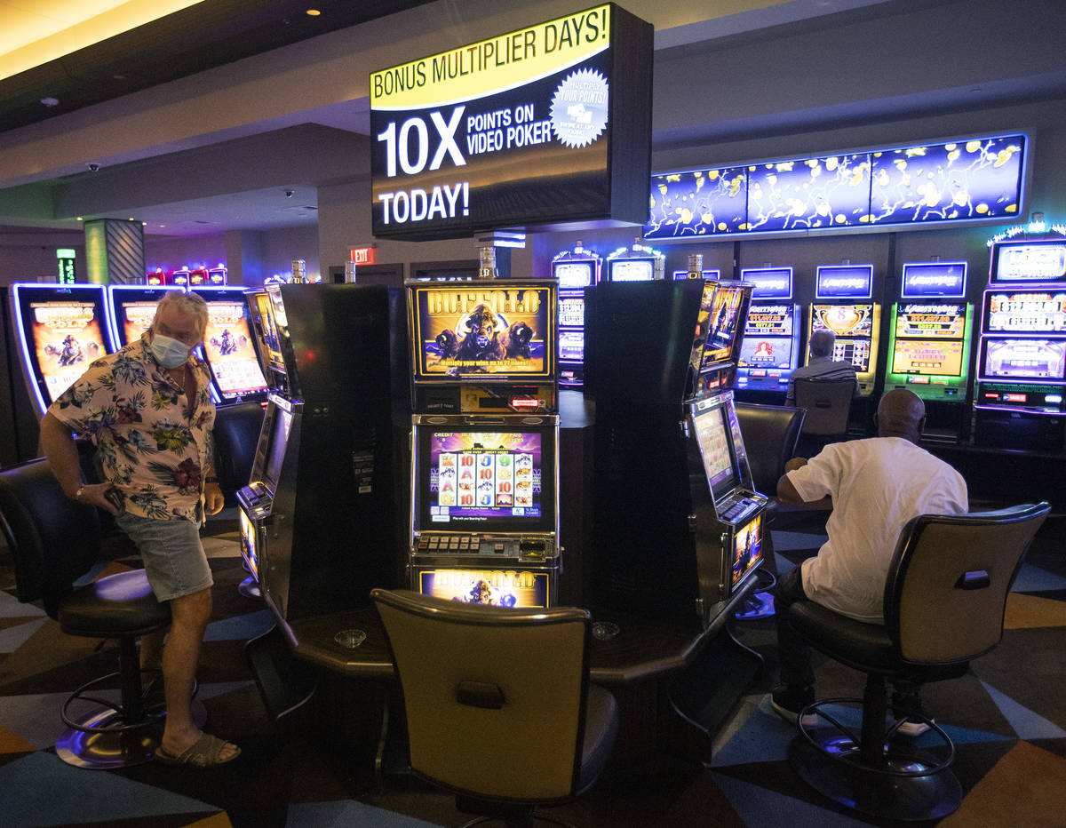 The casino floor has gamblers playing one seat apart to maintain social distance and slow the s ...