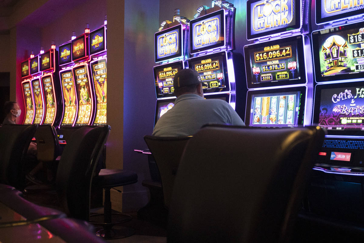 Gamblers sit far apart as casinos reopened amid the coronavirus pandemic at Palace Station on S ...