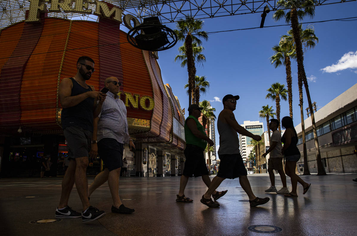 People walk around the Fremont Street Experience in downtown Las Vegas on Saturday, June 6, 202 ...