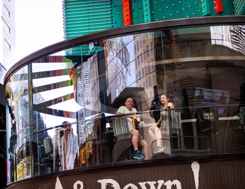 People take in the sights from the Whiskey Licker Up Saloon at the Fremont Street Experience in ...