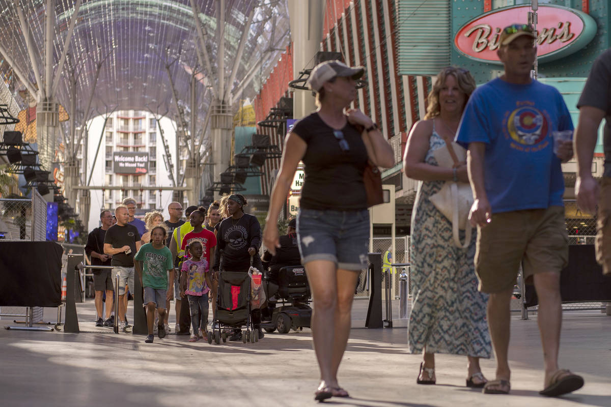 Tourists and locals return to Fremont Street Experience on the second day that casinos and othe ...