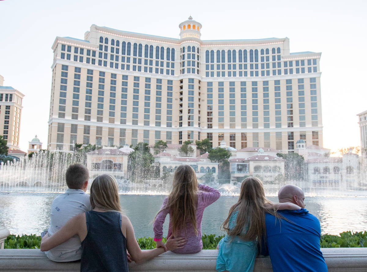 Cash, 11, Cassie, Lacey, 9, Lily, 9, and Mike Bowen watch the Bellagio fountain show to "Y ...