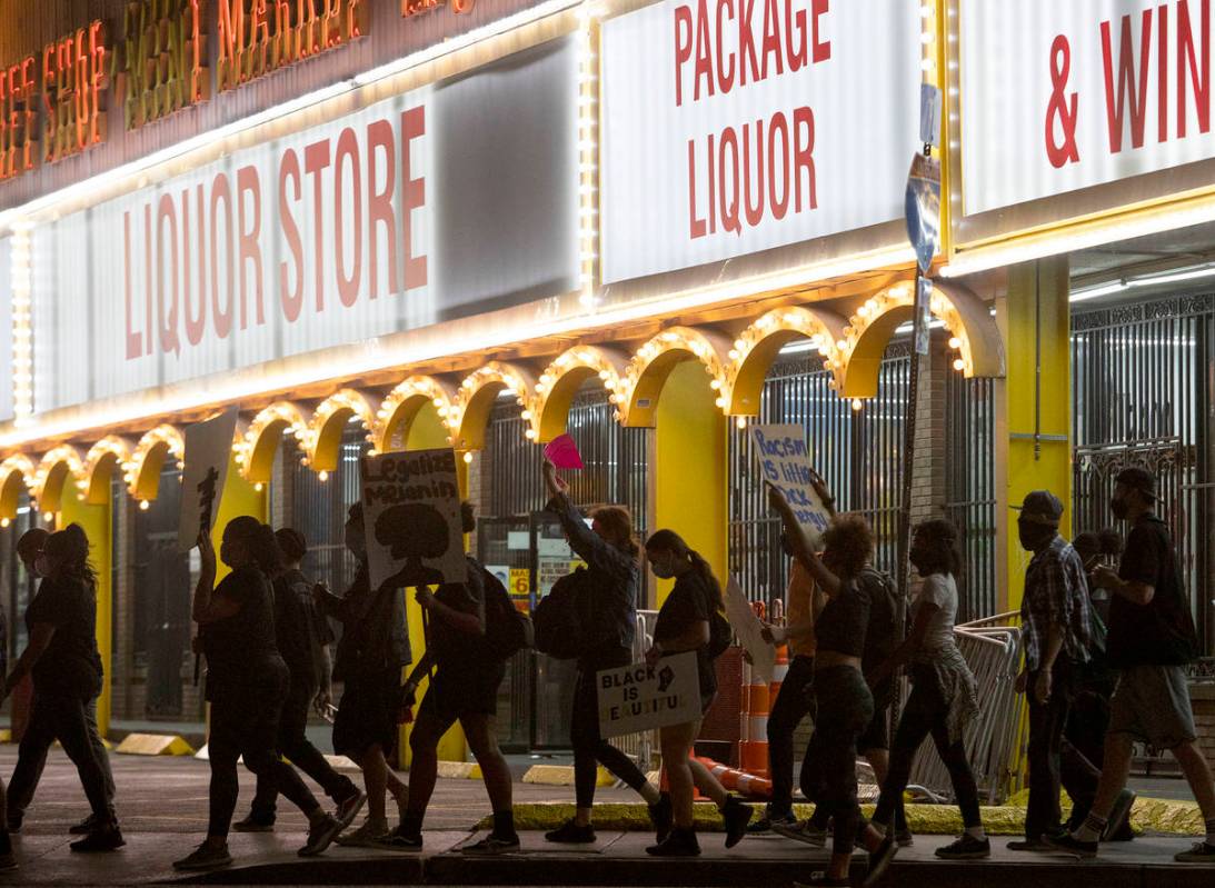 A small group of people march down Las Vegas Boulevard in protest of police brutality and the d ...