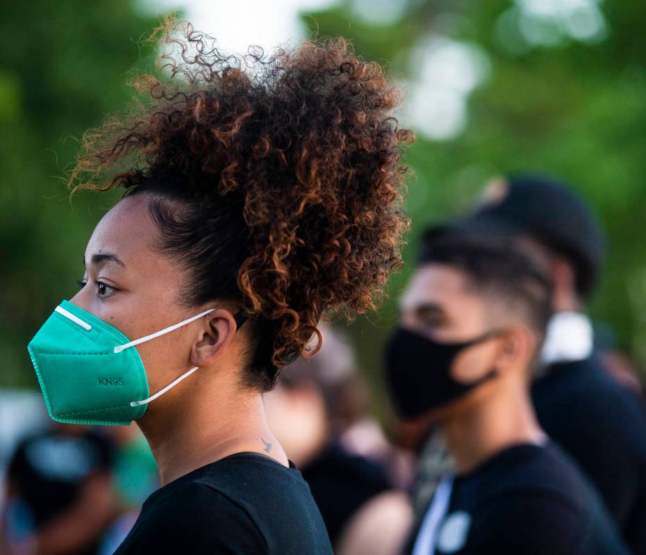 Nakita Fletcher, left, listens to a speaker during a press conference hosted by Organizing the ...