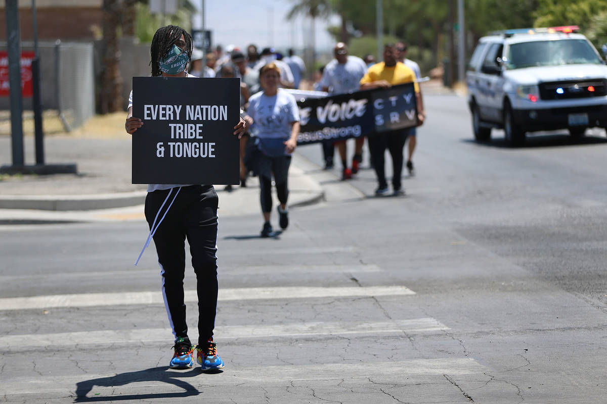 Jireh Johnson, a church member of Hope Church in Las Vegas, participates in a march lead by chu ...