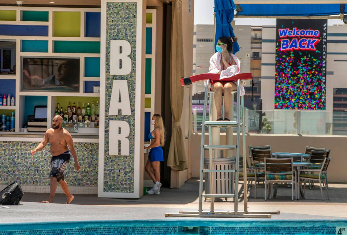 A lifeguard keeps watch as the bar is open about the pool at The Strat on Saturday, June 6, 202 ...