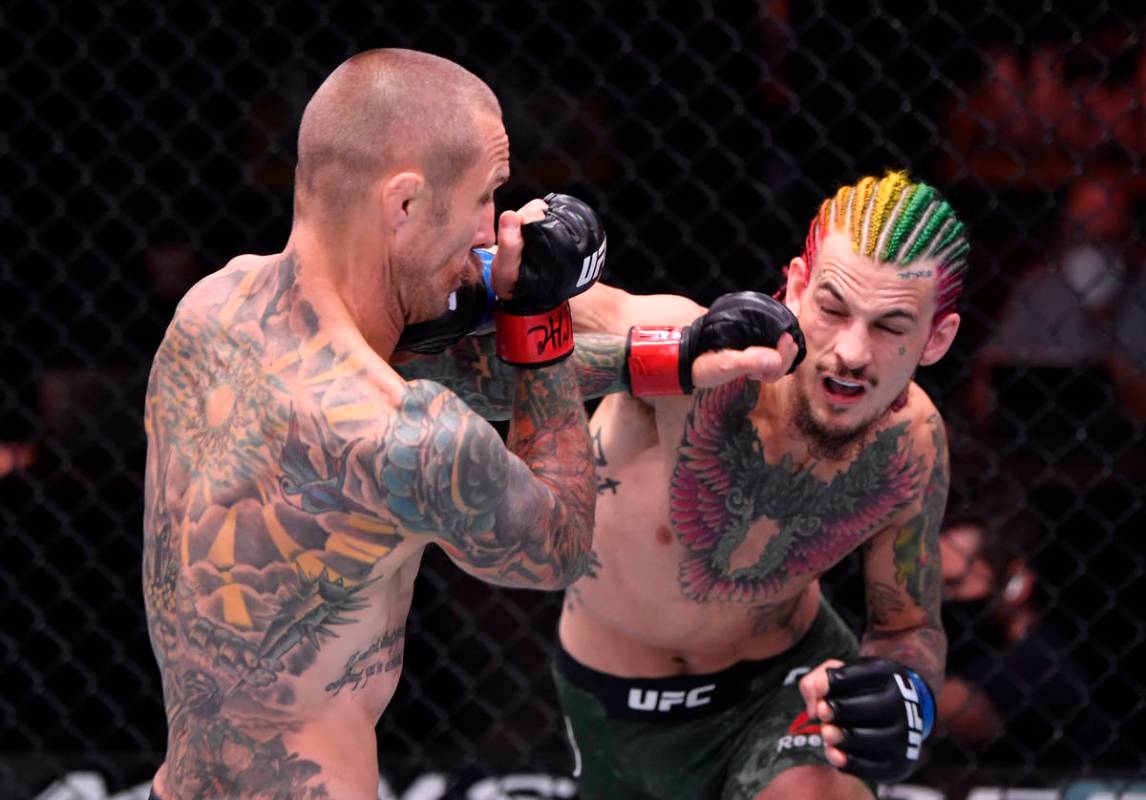 LAS VEGAS, NEVADA - JUNE 06: (R-L) Sean O'Malley punches Eddie Wineland in their bantamweight b ...