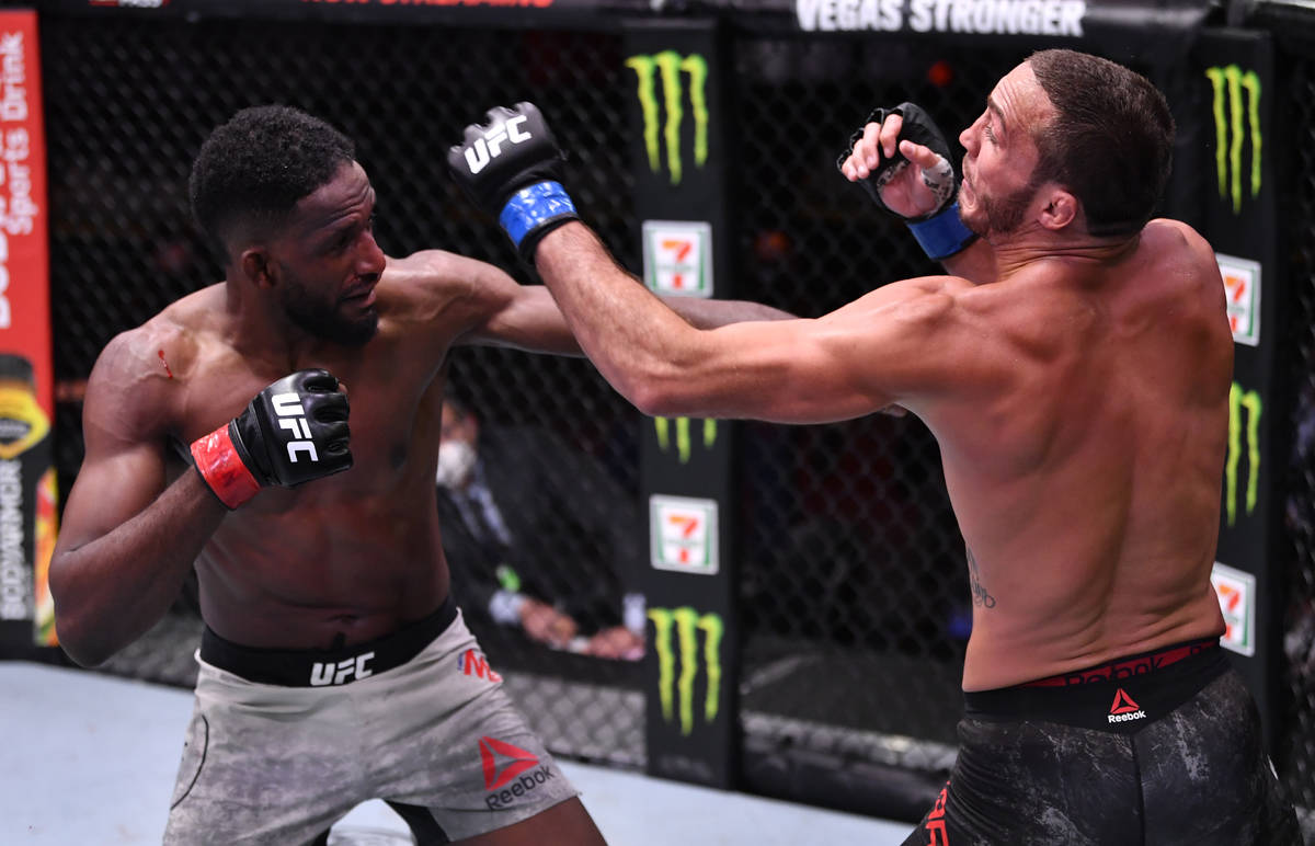 LAS VEGAS, NEVADA - JUNE 06: (L-R) Neil Magny punches Anthony Rocco Martin in their welterweigh ...