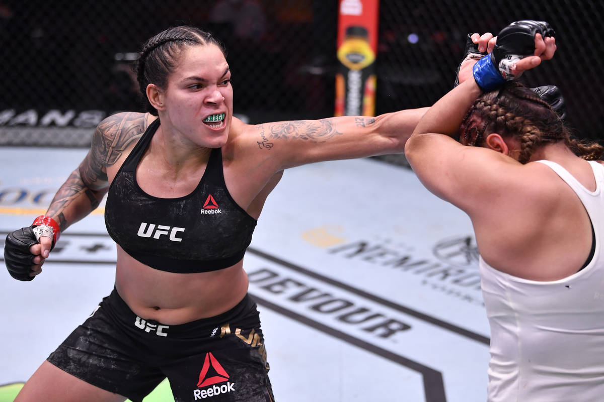 LAS VEGAS, NEVADA - JUNE 06: (L-R) Amanda Nunes of Brazil punches Felicia Spencer of Canada in ...