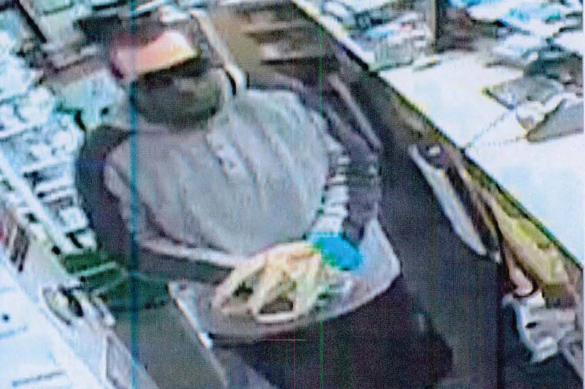 Screen shot from surveillance camera of robbery suspect at CVS Pharmacy at 9430 Del Webb Blvd. ...