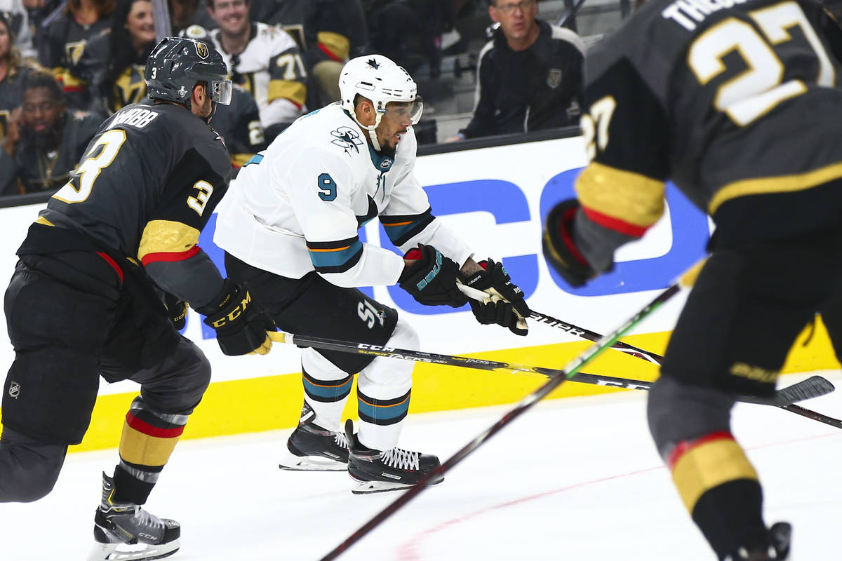 San Jose Sharks left wing Evander Kane (9) moves the puck past Golden Knights defenseman Brayde ...