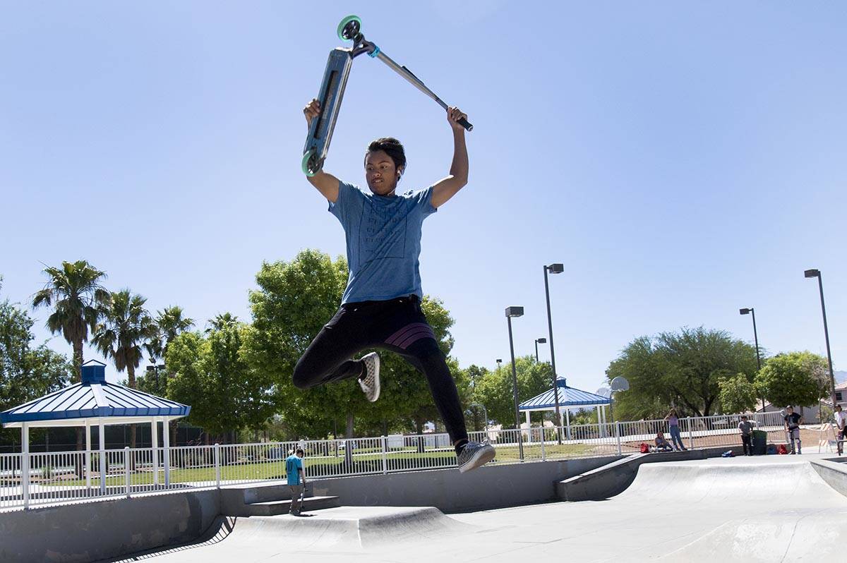 Izaiah Marure, 14, does a trick with his scooter at Duck Creek Skate Park in Las Vegas on Monda ...