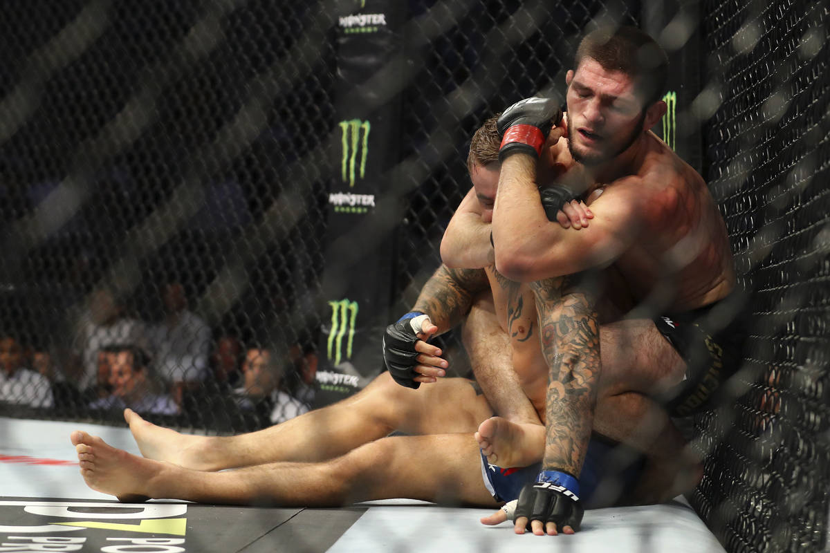 Russian UFC fighter Khabib Nurmagomedov choke holds UFC fighter Dustin Poirier, of Lafayette, L ...