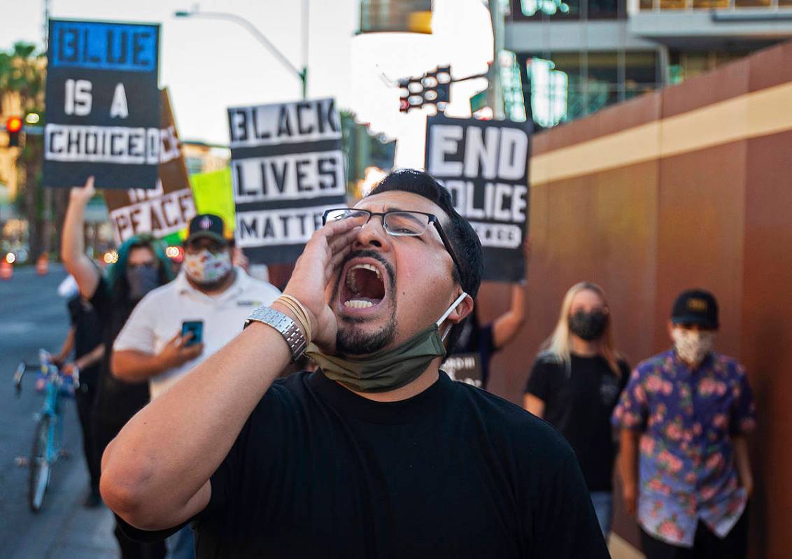 Edgar Flores leads a march north on the Strip during a vigil/walk for Jorge Gomez, who was fata ...