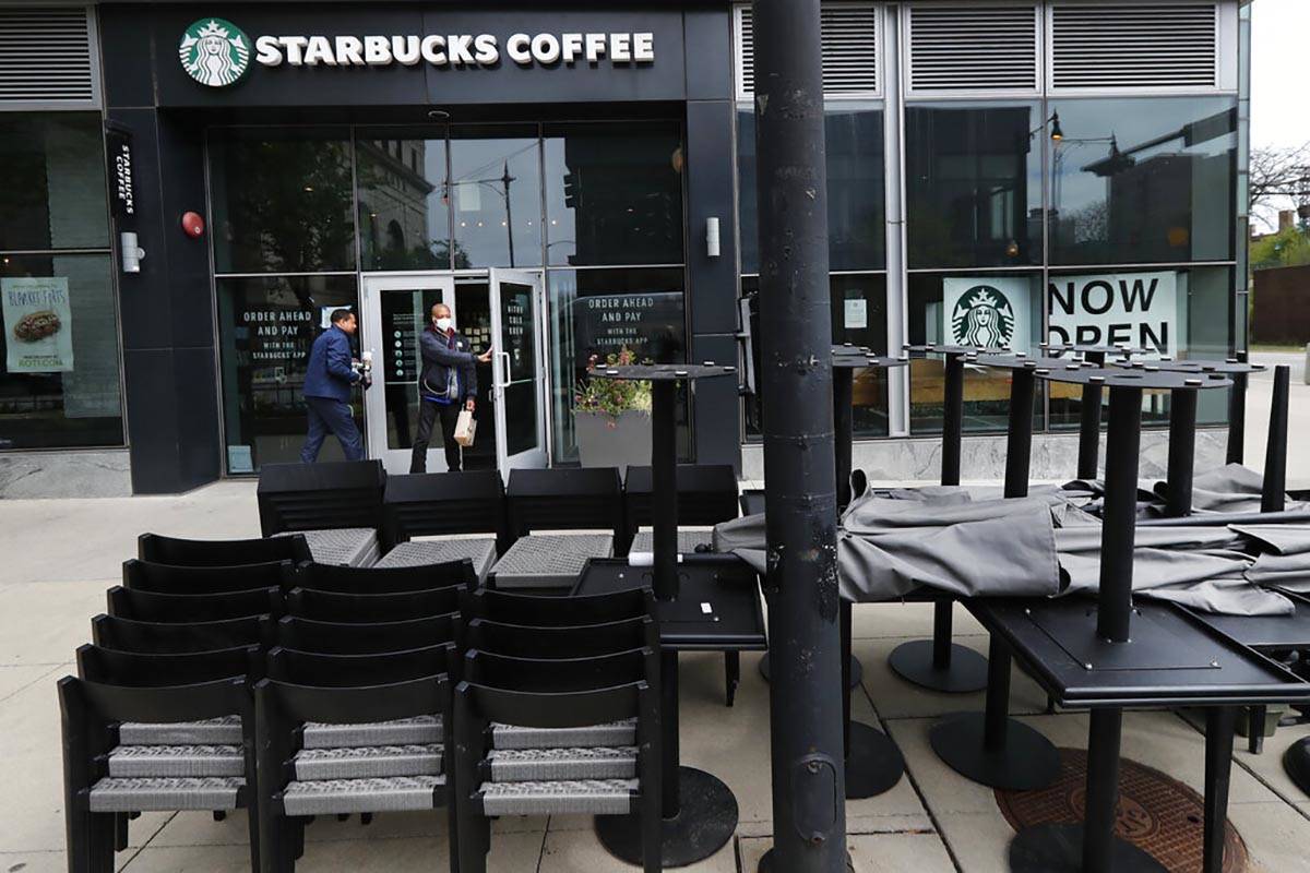 In a May 21, 2020, file photo, patrons to a Starbucks in the Chicago neighborhood of Hyde Park ...