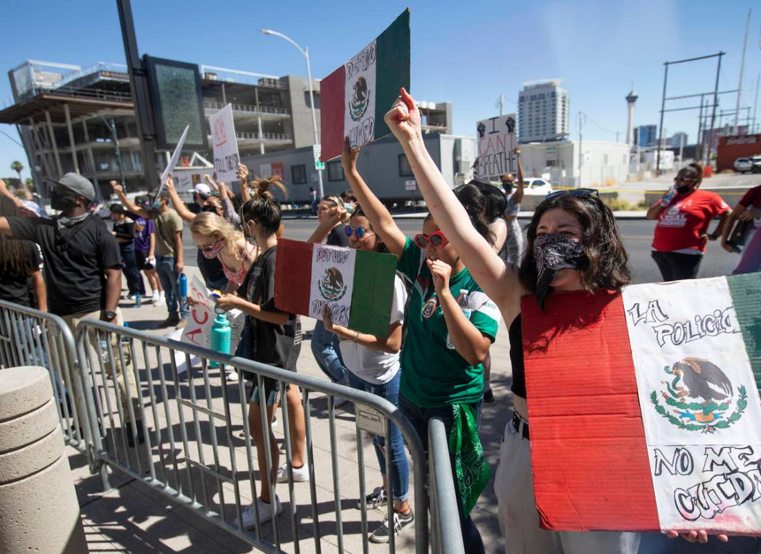 Outside Las Vegas City Hall, Leslie Fausto, right, demonstrates in an effort to defund the Metr ...