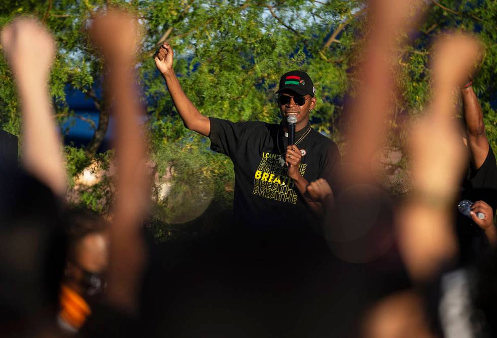 Rev. Stretch Sanders sings "We Shall Overcome" with thousands of people who showed up at a Blac ...