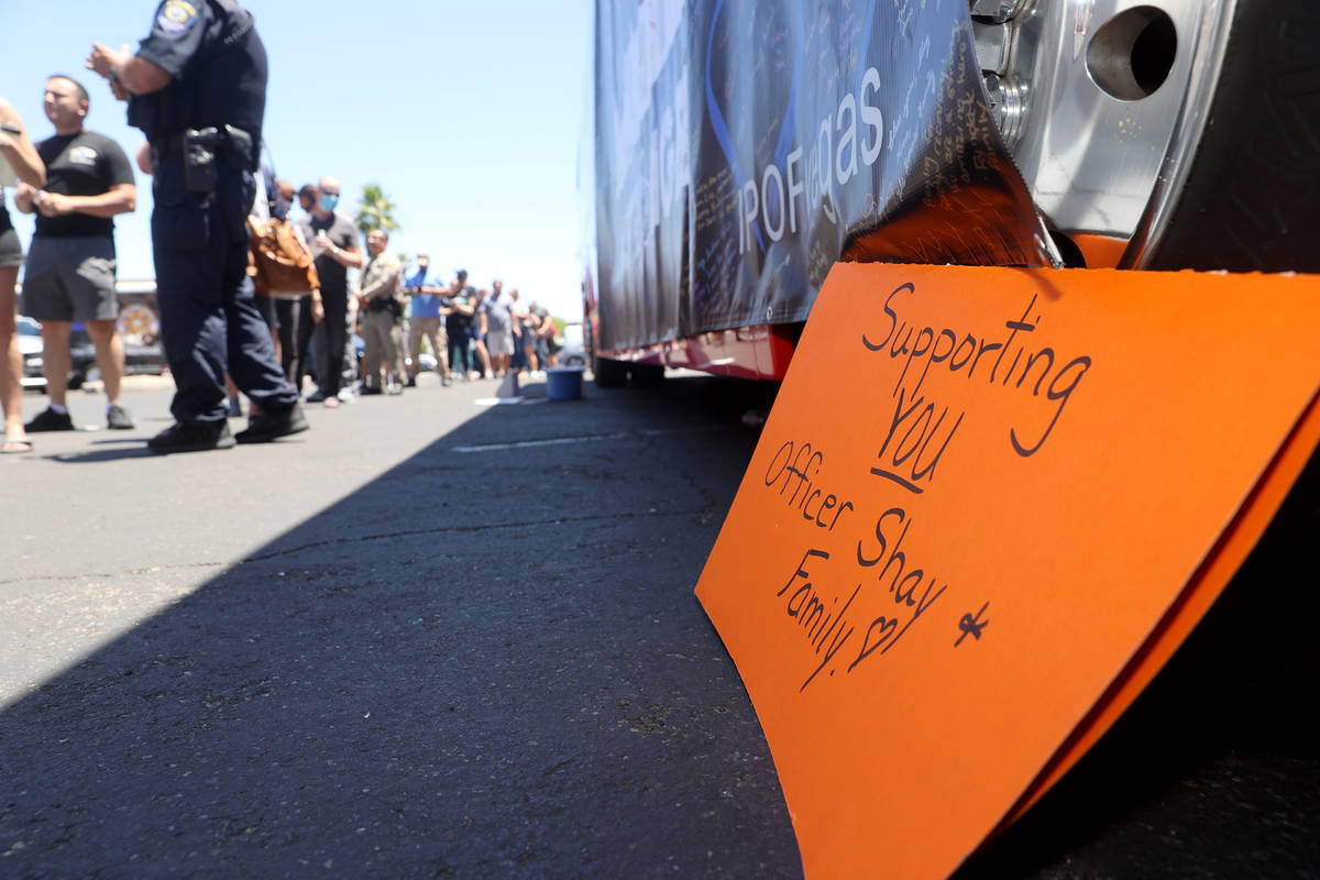 People wait in line to buy T-shirts during a fundraiser for Las Vegas police officer Shay Mikal ...