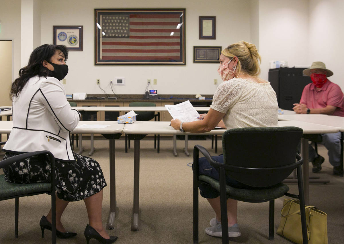 Stacey Campbell, left, chief deputy clerk at City of Las Vegas, and Molley Taylor, Expel Michel ...