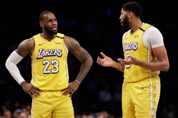 Los Angeles Lakers' LeBron James (23) talks to Anthony Davis (3) during the first half of an NB ...