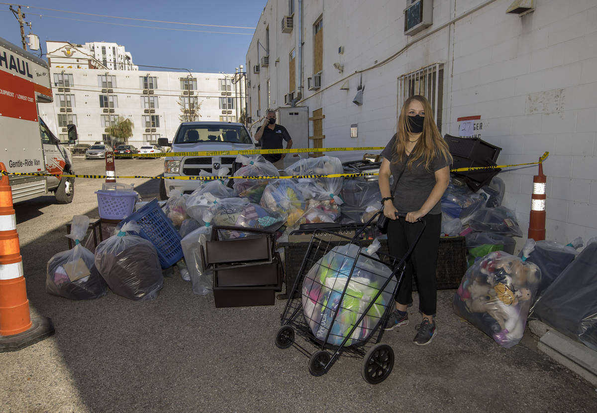 Former resident Ashley Rogers loads up some possessions from her and her mother's room in the ...