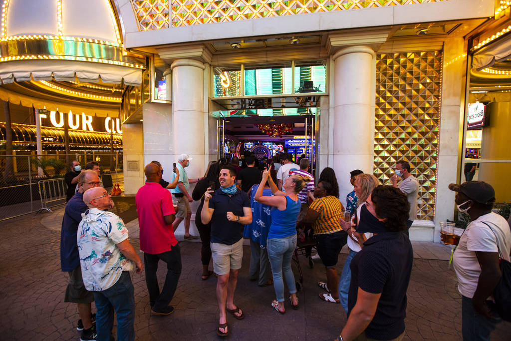 People enter the Golden Nugget just after midnight as hotel-casinos reopen in downtown Las Vega ...