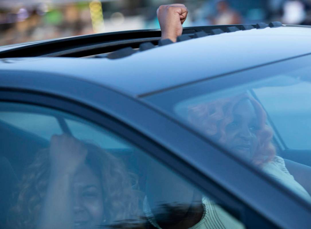 A vehicle cheers as it passes a protest against police brutality that marched from Molasky Fami ...