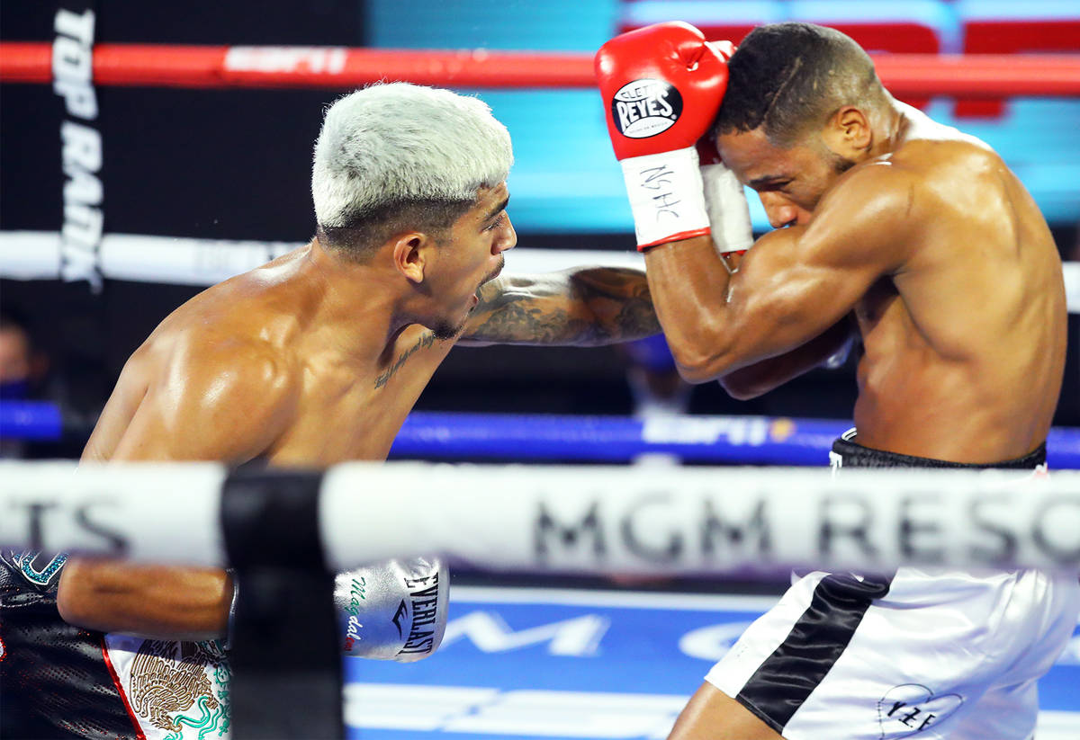 Jessie Magdaleno, left, lands a left against Yenifel Vicente during their featherweight fight T ...